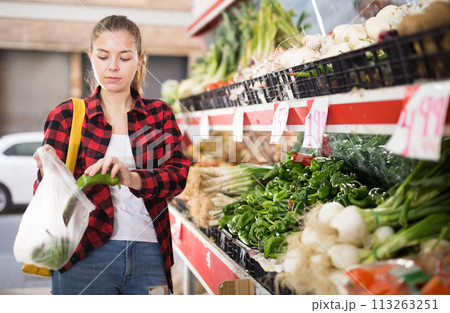 Portrait of cheerful female customer buying fresh pepper Portrait of cheerful female customer buying fresh pepper 113263251