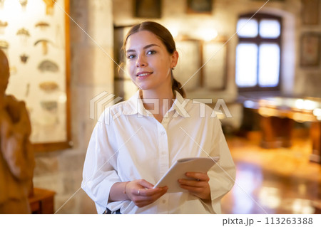 Woman visiting sculpture hall in historical museum 113263388