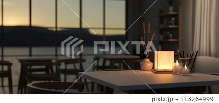 A table with a dim light from a table lamp in a contemporary romantic restaurant at night. A table with a dim light from a table lamp in a contemporary romantic restaurant at night. 113264999
