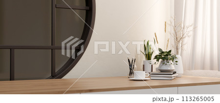 A minimalist wooden table with a space for display products against a white wall with a round window. A minimalist wooden table with a space for display products against a white wall with a round window. 113265005