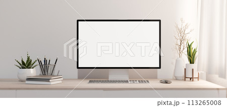 A minimalist white home office with a PC computer mockup on a wood table against the white wall. 113265008