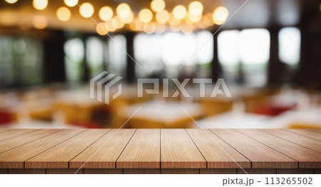 Empty wooden table top with lights bokeh on blur restaurant background. Empty wooden table top with lights bokeh on blur restaurant background. 113265502