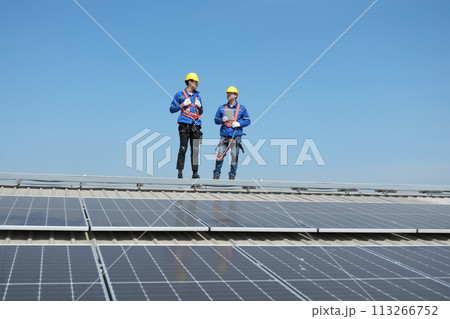 Team of engineers working at the factory 113266752
