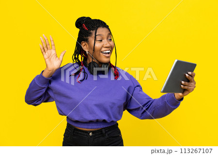 Woman Waving Hello During Video Call On Her Tablet Woman Waving Hello During Video Call On Her Tablet 113267107