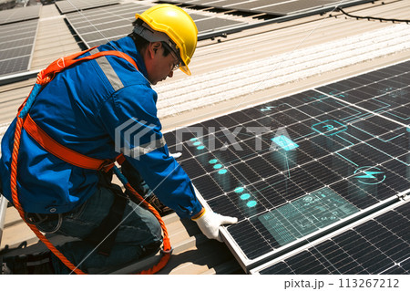 Engineers install solar cells on the roof of factory 113267212