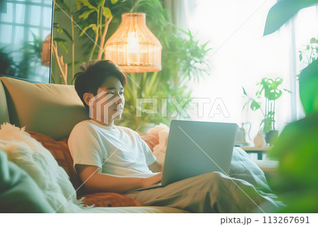 Connected Workspace: Young Man Engages in Laptop Communication Connected Workspace: Young Man Engages in Laptop Communication 113267691