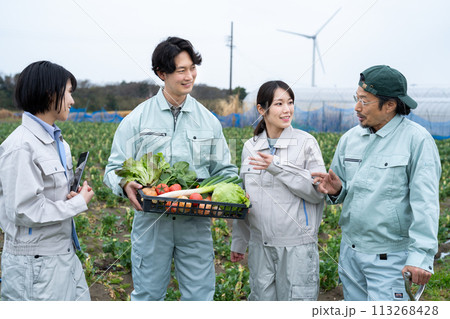 農作物を持って話をする農家の人達 113268428