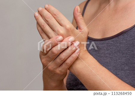 Woman hands showing numb hand Woman hands showing numb hand 113268450