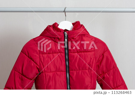 Red child puffer coat hanging 113268463