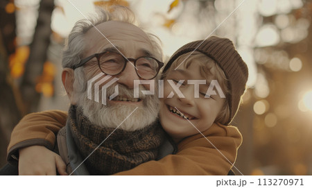 Grandfather laughing with grandson in autumn light 113270971