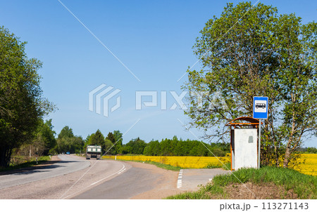 An empty bus stop on a sunny day, rural public transportation 113271143