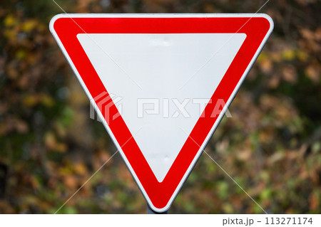 Give way road sign over blurred background Give way road sign over blurred background 113271174