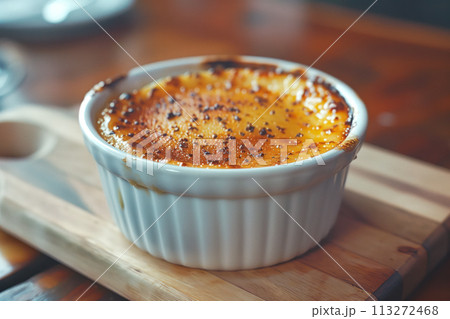 Creme brulee served in a classic ramekin, combination of creamy custard and caramelized sugar 113272468