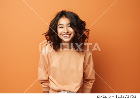 A young woman with short hair is smiling and wearing an orange shirt 113272752