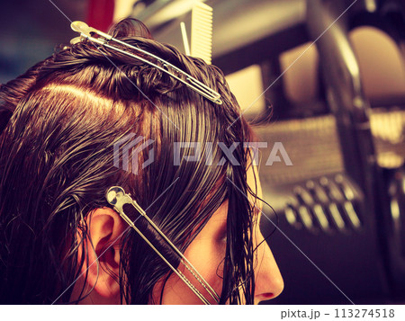 Woman getting her hairstyle done at hairdresser Woman getting her hairstyle done at hairdresser 113274518