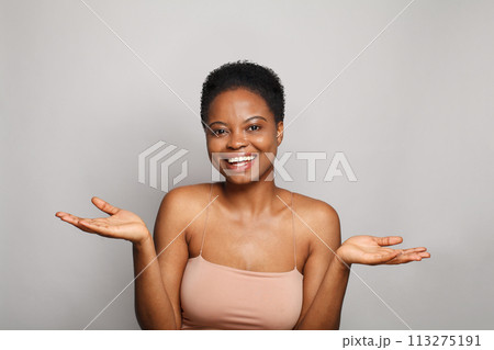 Pretty happy young woman holding empty blank hand palm. Advertising, product placement, Pretty happy young woman holding empty blank hand palm. Advertising, product placement, 113275191