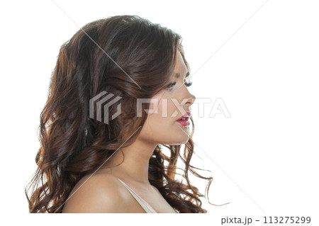 Healthy female model portrait. Beauty woman with clean skin, brown curly hair and makeup 113275299