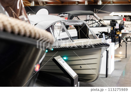 Many small big ship yachts at boat show exhibition indoors hall. Marine fishing yachting sailing vessel expo commercial trading business. Modern recreation sport water transport fair 113275989