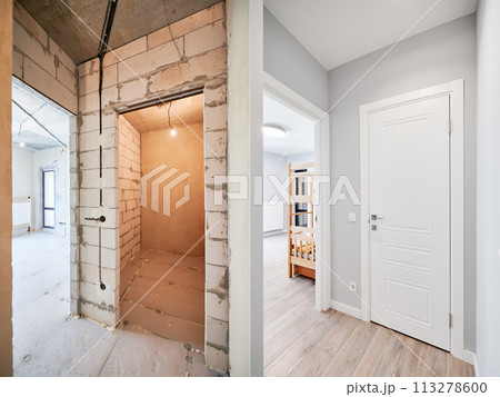 Old apartment with brick walls and new renovated flat doors, children room and elegant interior design. Comparison of apartment before and after restoration. Home renovation concept. Old apartment with brick walls and new renovated flat doors, children room and elegant interior design. Comparison of apartment before and after restoration. Home renovation concept. 113278600