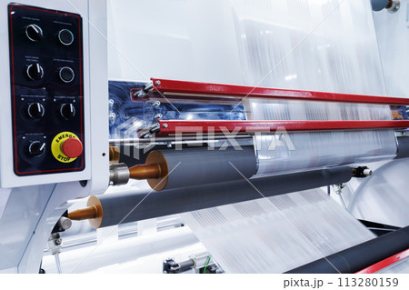 new innovative technology of automatic label printing machine with digital control panel. printing on continuous plastic film for wrapping on food product packaging in the printing factory. new innovative technology of automatic label printing machine with digital control panel. printing on continuous plastic film for wrapping on food product packaging in the printing factory. 113280159