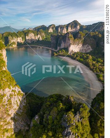 An aerial view of a Railay beach of water surrounded by mountains An aerial view of a Railay beach of water surrounded by mountains 113280270