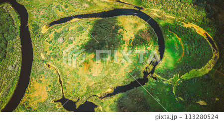 Aerial View Green Forest Woods And River Landscape In Sunny Spring Summer Day. Top View Of Beautiful European Nature From High Attitude In Autumn Season. Drone View. Bird's Eye View Aerial View Green Forest Woods And River Landscape In Sunny Spring Summer Day. Top View Of Beautiful European Nature From High Attitude In Autumn Season. Drone View. Bird's Eye View 113280524