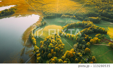 Aerial View Of Green Forest And Meadow Hill Landscape Near River. Top View Of Beautiful Nature From High Attitude. Aerial View Of Green Forest And Meadow Hill Landscape Near River. Top View Of Beautiful Nature From High Attitude. 113280535