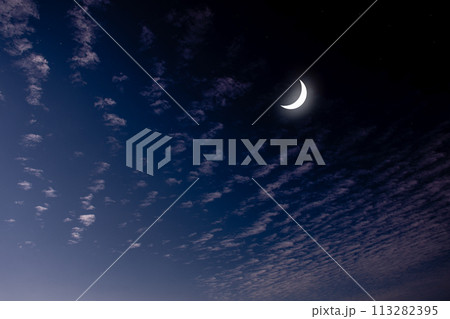 See the Islamic moon in the night sky. Evening sky and the vastness in the dark are beautiful twinkling stars. The crescent moon concept, the symbol of Islam, begins the month of Ramadan, eid al fitr 113282395