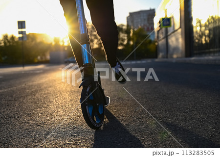 Beautiful and blonde girl practicing long board on the road 113283505