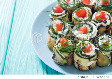 Zucchini rolls with cream cheese , tomatoes and dill Zucchini rolls with cream cheese , tomatoes and dill 113283528