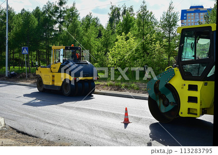 Large view on the road rollers working on the new road construction site 113283795