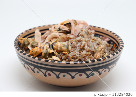 buckwheat porridge with seafood, sea cocktail with buckwheat, tasty and healthy food, 113284020