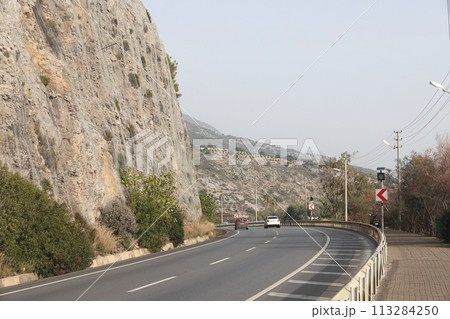 Road to Alanya and Cleopatra beach, sheer cliffs, Antalya, Turkey. Road to Alanya and Cleopatra beach, sheer cliffs, Antalya, Turkey. 113284250