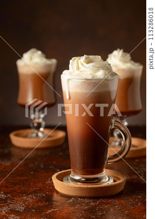 Creamy milk chocolate drinks with whipped cream. 113286018