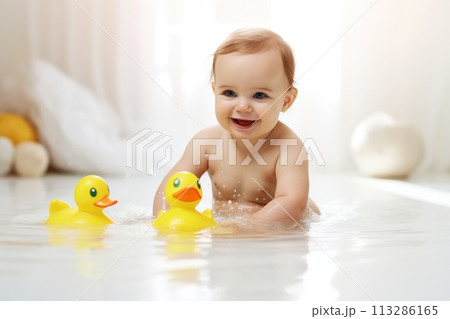 Baby in bath of water with yellow toy duck, smiling Baby in bath of water with yellow toy duck, smiling 113286165
