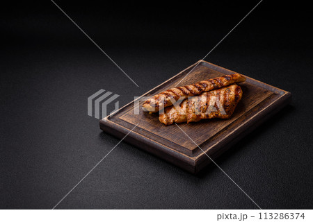 Delicious fresh grilled chicken fillet with spices and herbs Delicious fresh grilled chicken fillet with spices and herbs 113286374