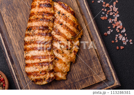 Delicious fresh grilled chicken fillet with spices and herbs Delicious fresh grilled chicken fillet with spices and herbs 113286381