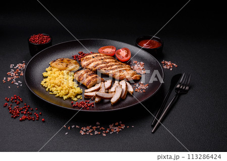 Delicious fresh grilled chicken fillet with spices and herbs Delicious fresh grilled chicken fillet with spices and herbs 113286424