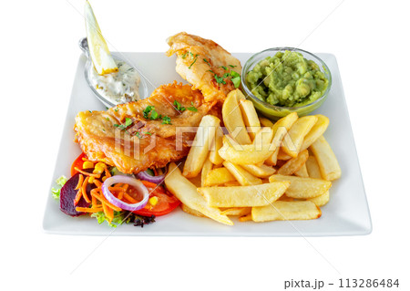 Traditionally a Mediterranean dish of fried fish and fries with salad and sauces. Close-up on a white background. Traditionally a Mediterranean dish of fried fish and fries with salad and sauces. Close-up on a white background. 113286484