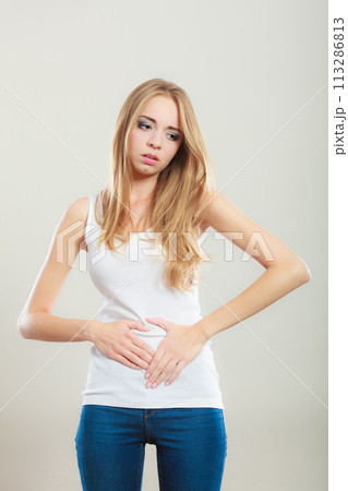 Girl suffering from stomach pain Girl suffering from stomach pain 113286813