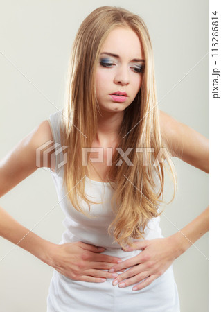 Girl suffering from stomach pain Girl suffering from stomach pain 113286814