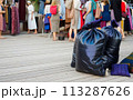 Large pile of garbage and textile waste in black bags for recycling, background and copyspace 113287626