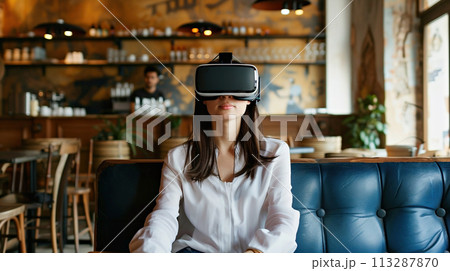 A young girl experiences virtual reality in quiet cozy cafe. Modern innovative technologies in everyday life, education, entertainment, psychological reboot 113287870