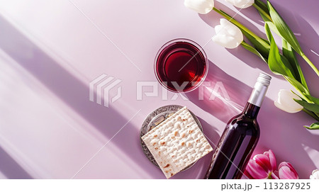 Jewish holiday Passover, Passover celebrations, traditional kosher food. Matzo, red kosher wine, beautiful spring tulips, purple pastel simple background, top view Jewish holiday Passover, Passover celebrations, traditional kosher food. Matzo, red kosher wine, beautiful spring tulips, purple pastel simple background, top view 113287925
