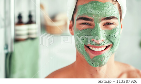 A man is doing home SPA beauty treatments, in the bathroom wearing a green mask, radiating joy and practicing self-care. Soft masculinity, daily self-care A man is doing home SPA beauty treatments, in the bathroom wearing a green mask, radiating joy and practicing self-care. Soft masculinity, daily self-care 113287926