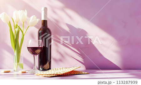 Jewish holiday Passover, Passover celebrations, traditional kosher food. Matzah, red kosher wine, beautiful spring tulips , light pink background with bright sunlight and shadows, copy space 113287939