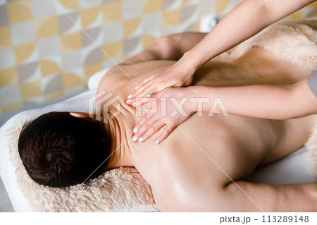 Man Relaxing with Face-Down Massage on Comfortable Couch 113289148