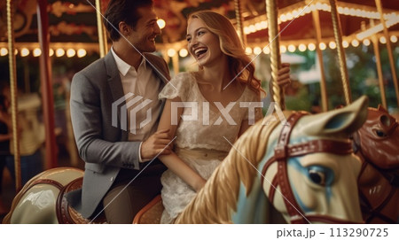 Romantic couple having a delightful time on a vibrant carousel at the amusement park on a sunny day 113290725