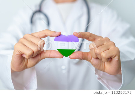 Queer Pride Day and LGBT pride month concept. Doctor hand holding purple, white and green heart shape with Stethoscope for Lesbian, Gay, Bisexual, Transgender, genderqueer and Pansexual community 113293173