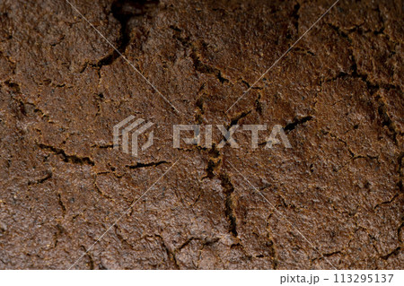 dark square loaf of bread on the table 113295137